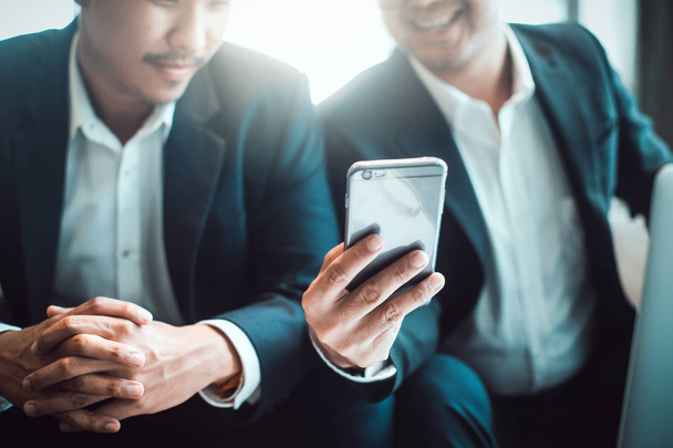 Два молодых бизнесмена используют тачпад на встрече
 - Фото, изображение