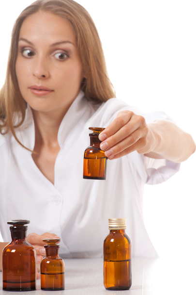Woman doctor with medication in glass bottles - 写真・画像