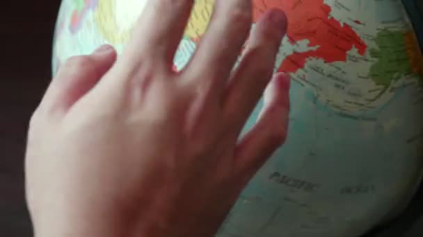 closeup view of hand moving globe - Felvétel, videó