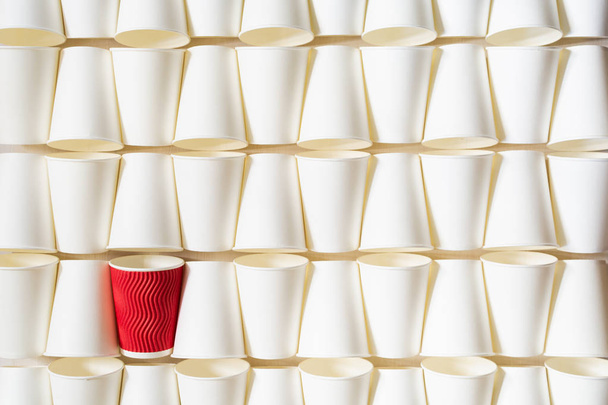 Background pattern of white paper cups with red cup in the middle - Photo, Image