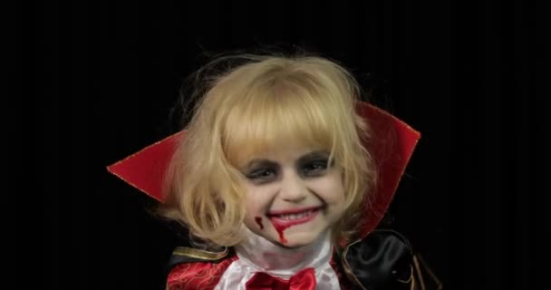 Dracula child. Girl with halloween make-up. Vampire kid with blood on her face - Footage, Video