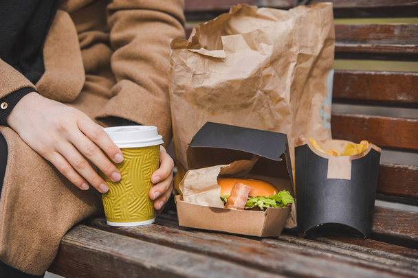 mains de femme fermer tenant hamburger avec tasse de café. restauration rapide
 - Photo, image