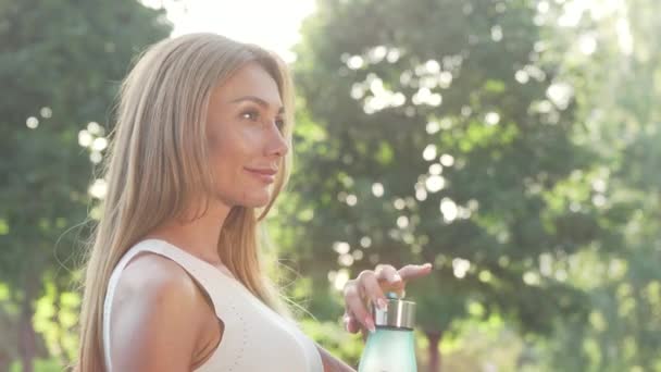 Beautiful woman enjoying drinking water after outdoor workout - Footage, Video