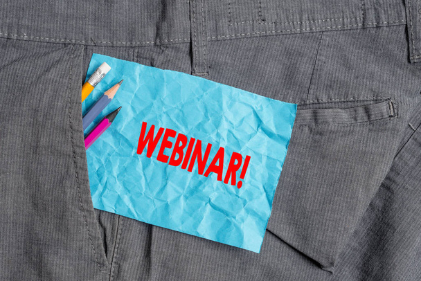 Text sign showing Webinar. Conceptual photo a seminar or other presentation that takes place on the Internet Writing equipment and blue note paper inside pocket of man work trousers. - Photo, Image