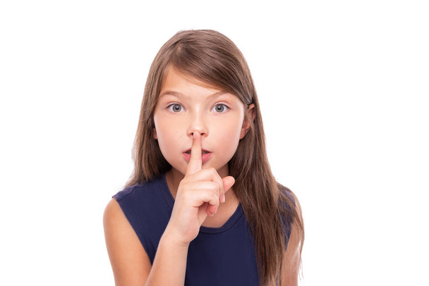 Little girl presses her finger to her lips. - Фото, зображення
