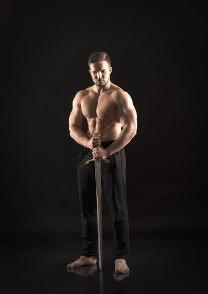 Strong athletic man showes naked muscular body. - Photo, image