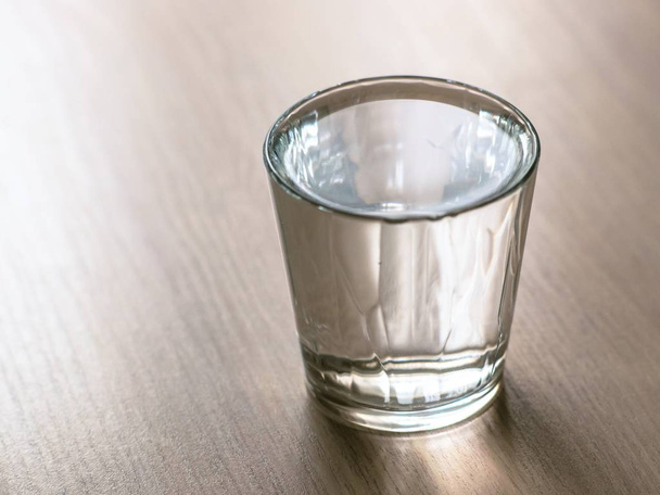Full glass of water on the wooden table. - Φωτογραφία, εικόνα