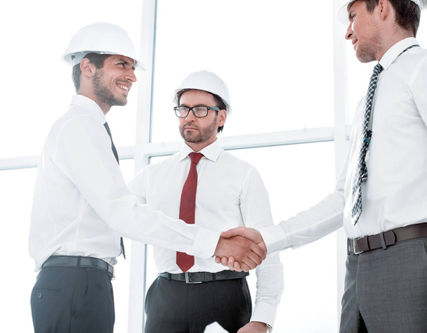 Two architects shaking hands after a meeting in office - Φωτογραφία, εικόνα