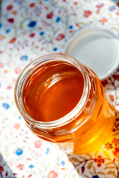 Open jar with fresh yellow organic bio honey - Fotografie, Obrázek