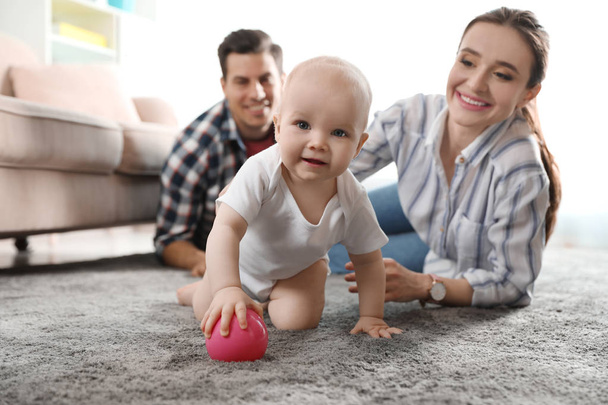 Adorable little baby crawling near parents at home - Foto, imagen