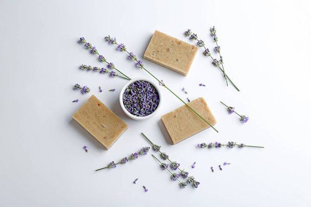 Composition with hand made soap bars and lavender flowers on white background, top view - Foto, Bild