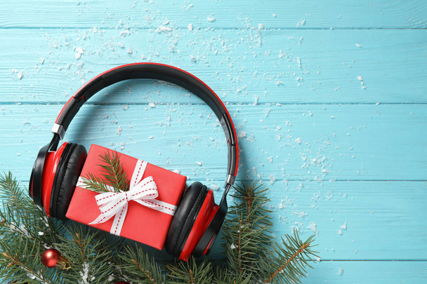 Flat lay composition with headphones on blue wooden background, space for text. Christmas music concept - Foto, Bild