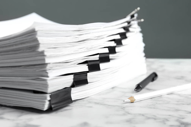 Stack of documents with binder clips on marble table, closeup - Фото, зображення