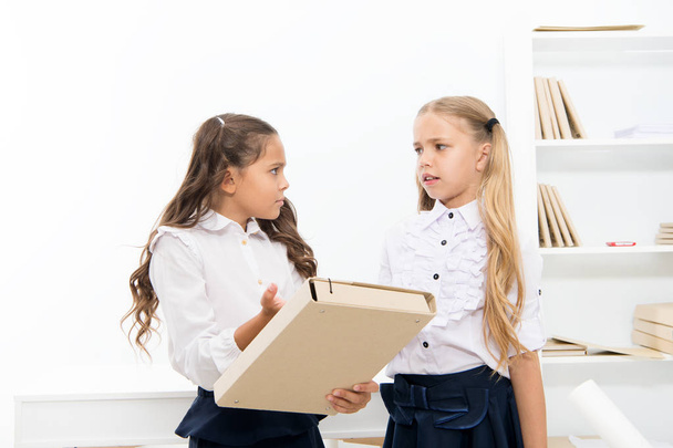Needing homework help. Adorable small children holding file with homework in classroom. Doing homework assignment. Too much homework is bad for kids - Foto, Imagen