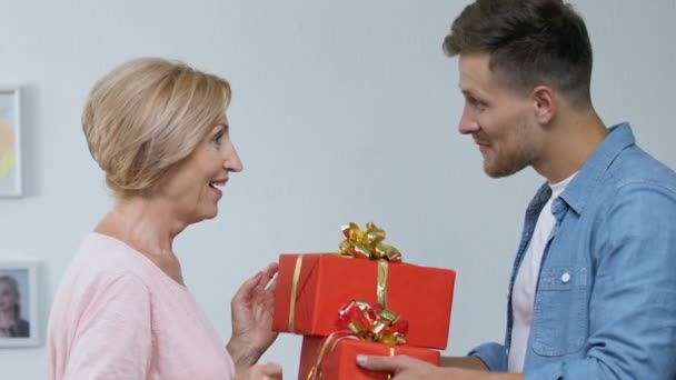 Son presenting gift to mother, displeased wife looking at camera, attention lack - Záběry, video