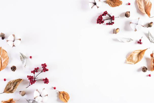 Autumn composition. autumn leaves, red berries, acorn nuts and white cotton head on white background. Flat lay, top view copy space. - Fotó, kép