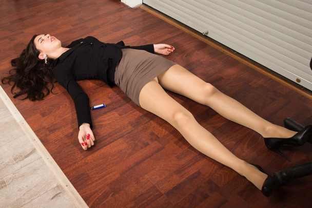 Lifeless businesswoman in a office lying on the floor - Fotó, kép