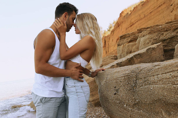 beautiful lovely couple wearing jeans,posing at summer beach - Foto, imagen