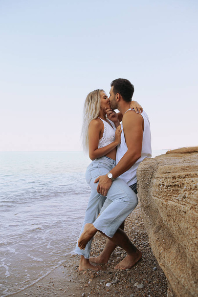 beautiful lovely couple wearing jeans,posing at summer beach - Fotografie, Obrázek