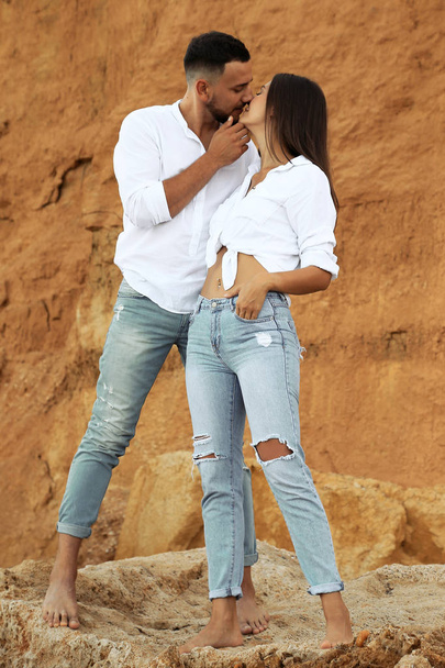 beautiful lovely couple wearing jeans,posing at summer beach - 写真・画像