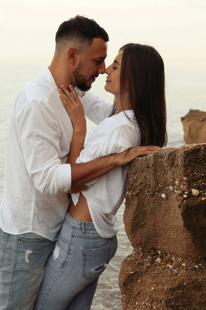 beautiful lovely couple wearing jeans,posing at summer beach - Φωτογραφία, εικόνα