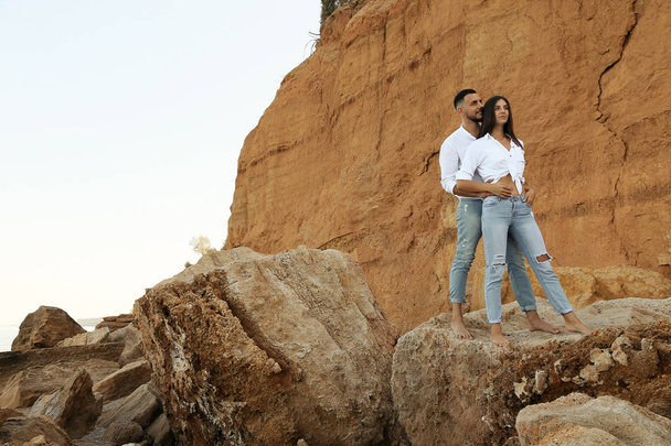 beautiful lovely couple wearing jeans,posing at summer beach - Zdjęcie, obraz
