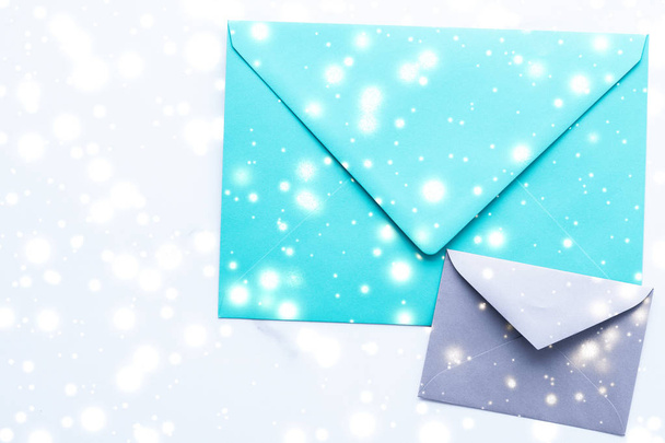 Winter holiday blank paper envelopes on marble with shiny snow f - Photo, Image
