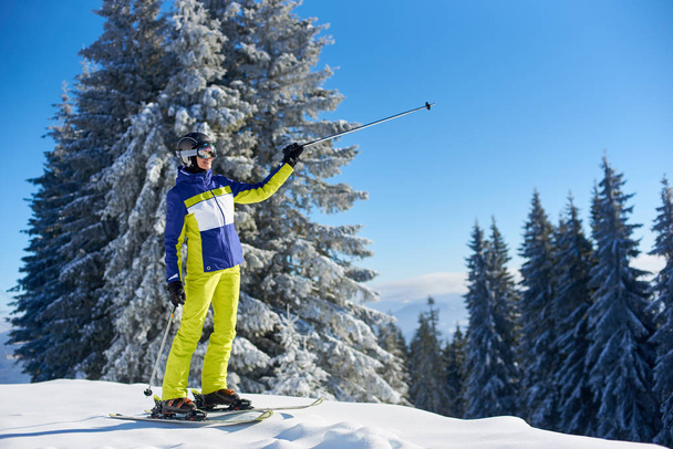Rejoicing woman coming up on mountain top with ski lift - Photo, Image