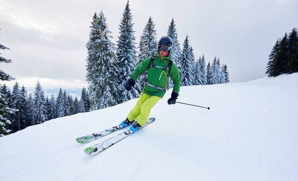 Skier man backcountry skiing on ski slope during vacation time - Photo, Image
