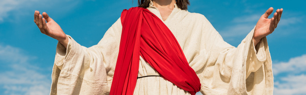 panoramic shot of jesus with outstretched hands against blue sky  - Photo, image