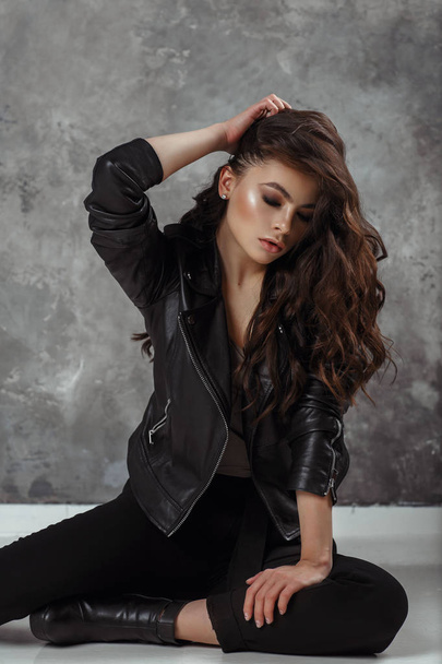 Young beautiful woman in a black jacket - Fotoğraf, Görsel