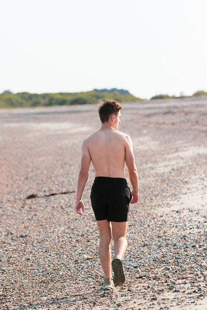 Shirtless on a beach - Foto, afbeelding