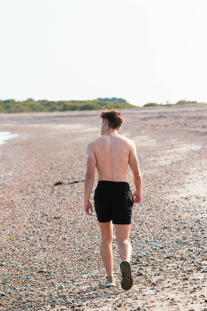 Shirtless on a beach - Valokuva, kuva