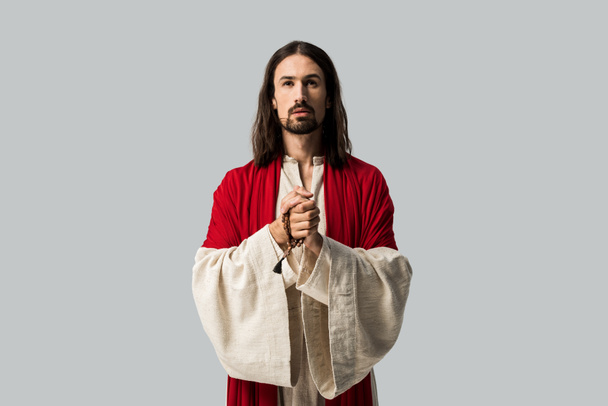 handsome man praying with clenched hands isolated on grey - Photo, Image