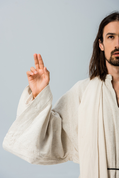 cropped view of bearded man in jesus robe gesturing isolated on grey  - Fotó, kép