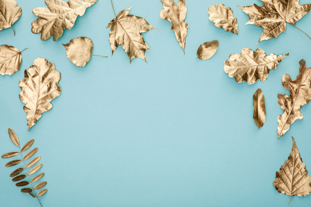 top view of autumnal golden leaves on blue background - Photo, Image
