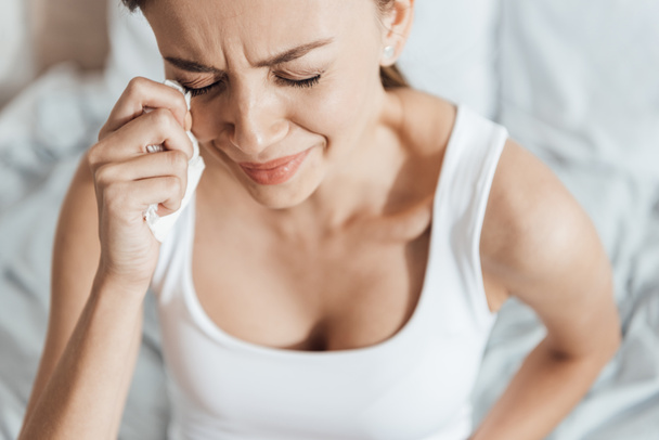 stressed young woman crying and wiping tears with napkin - Foto, Imagem
