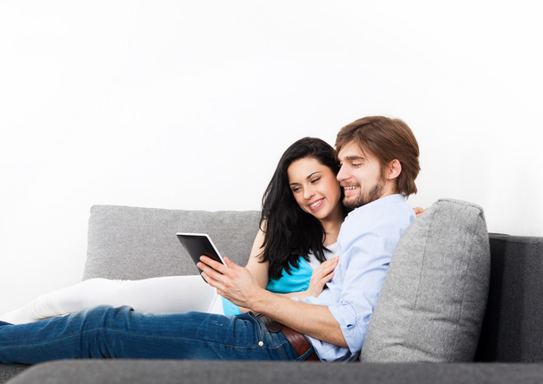 Couple using tablet touch screen pad - Fotó, kép