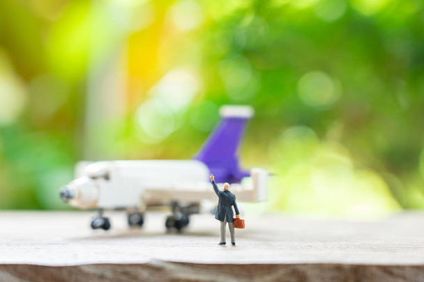 Miniature people businessmen standing with Plane model as backgr - Photo, Image