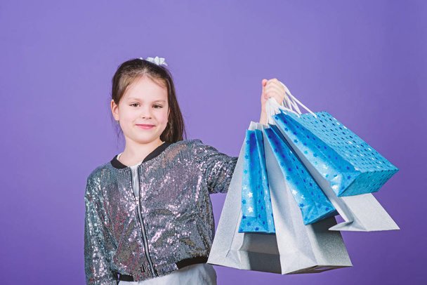 Shopping day. Child hold bunch packages. Kids fashion. Birthday girl. Surprise gift. Girl with shopping bags violet background. Shopping and purchase. Get better looking. Black friday. Sale discount - Foto, immagini