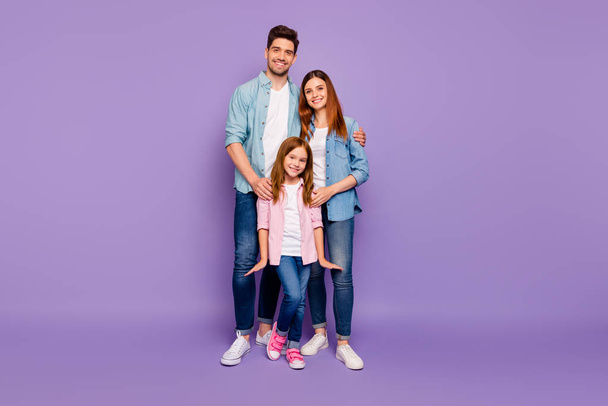 Full size photo of dad mom and little foxy lady posing for family portrait wear casual clothes isolated purple background - Foto, Bild