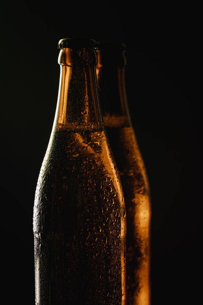 glass bottles of beer with water drops isolated on black - Foto, immagini