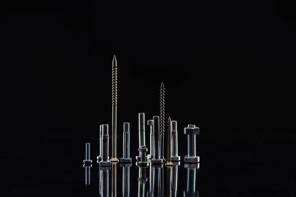 various metallic screws isolated on black with copy space - Fotó, kép