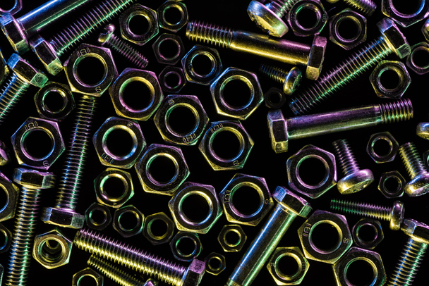 top view of scattered steel bolts and nuts isolated on black - Photo, Image