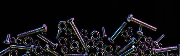 panoramic shot of scattered steel nuts and bolts isolated on black with copy space - Photo, Image