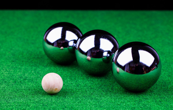 Steel balls on green surface - Фото, изображение