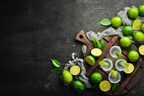 Tequila salt and lime. Alcohol. On a black stone background. Top view. Free space for your text. - Photo, Image