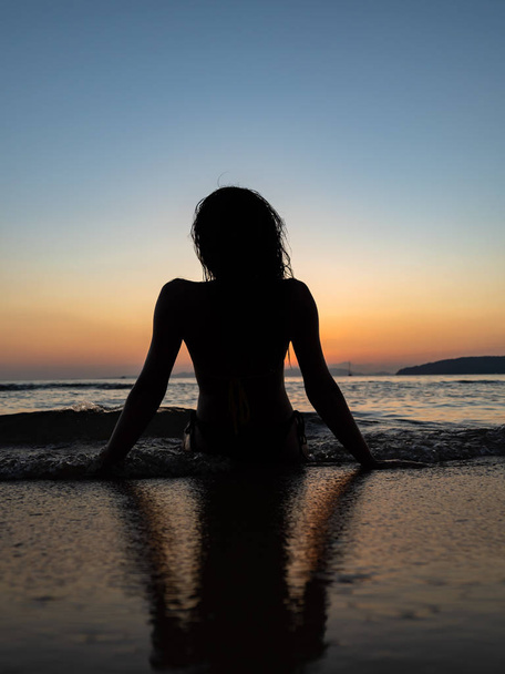woman sunbathing on the tropical beach - 写真・画像