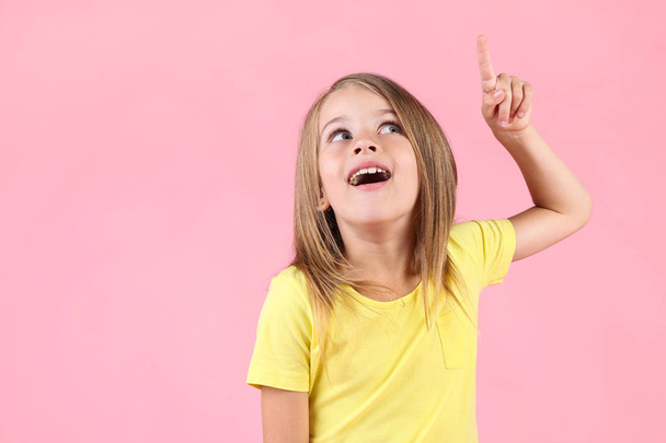 Beautiful little girl on pink background - Valokuva, kuva