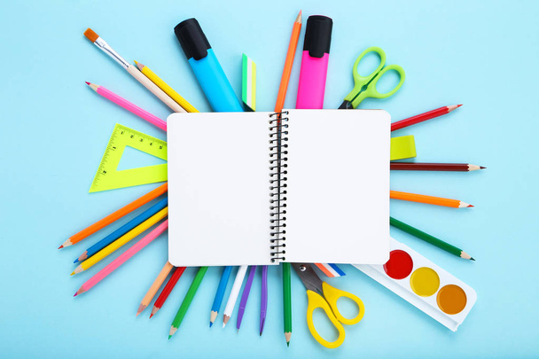 Different school supplies and blank sheet of paper on blue backg - Φωτογραφία, εικόνα